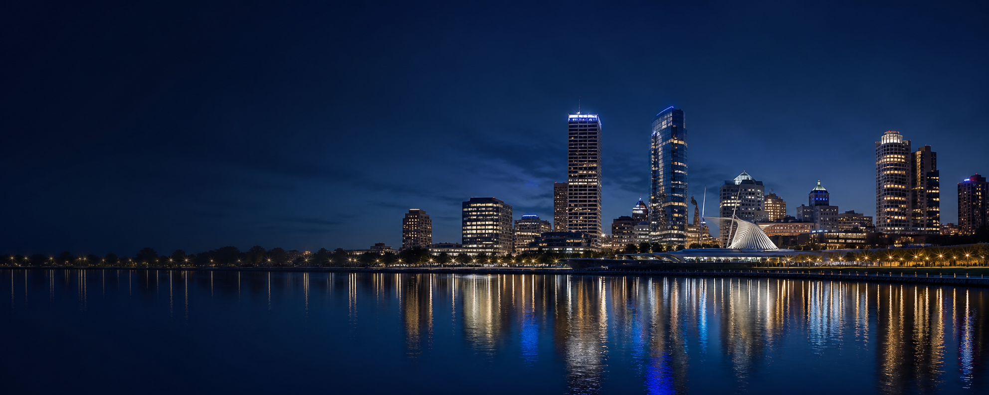 Milwaukee skyline reflecting across the water at night
